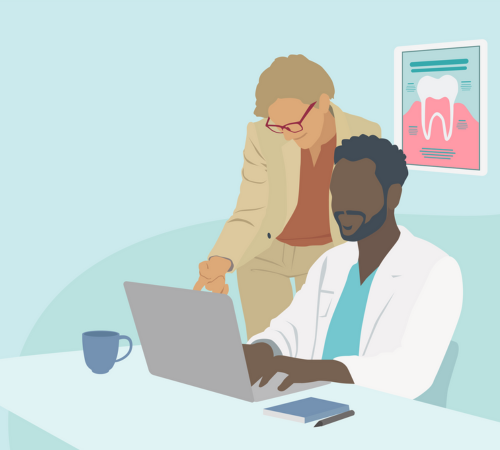 Two people working together on a computer.